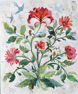 Fabric collage quilt artwork showing red blooms, green foliage, and blue birds on white textured background