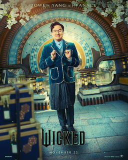Character in blue suit poses in grand circular library with ornate gold details
