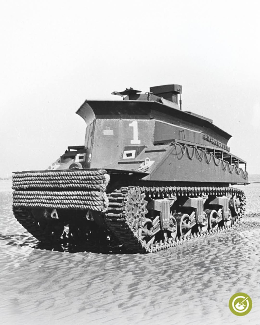 Armored recovery vehicle on sandy beach near the sea