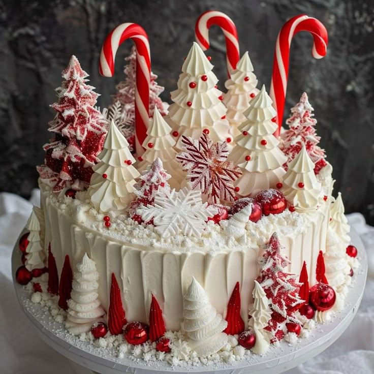 White Christmas cake with candy canes, meringue trees, and peppermint decorations
