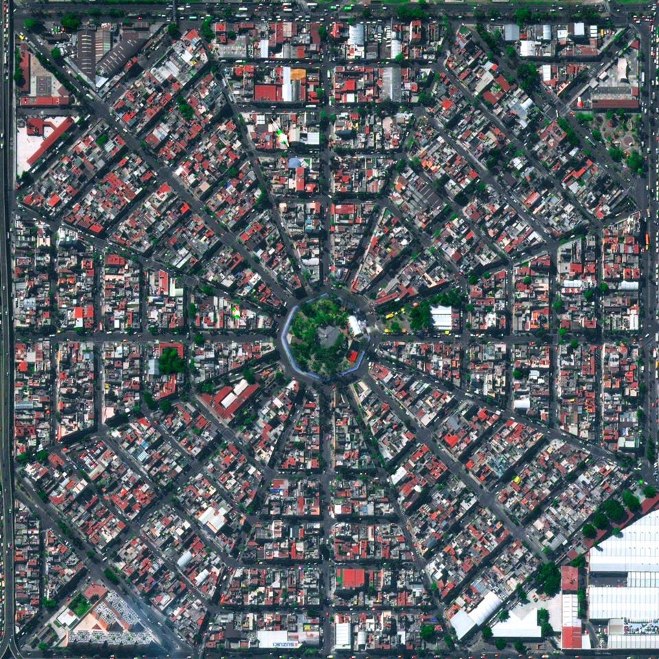 Aerial view of radial street pattern around Plaza del Ejecutivo, Mexico City with dense buildings and central plaza