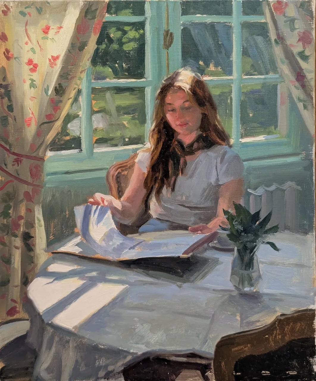 Painting of a young woman sitting at a sunlit table by a window, with a book and a small vase of flowers