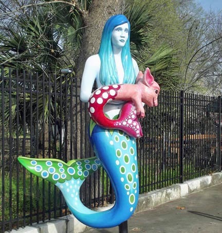 Stone mermaid sculpture displayed outdoors