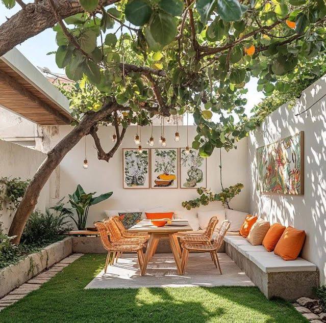 Sunlit outdoor patio with table, chairs, bench seating, and leafy vines overhead