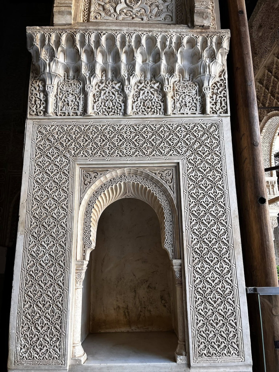 Ornate Spanish wooden entrance door set in a stone facade