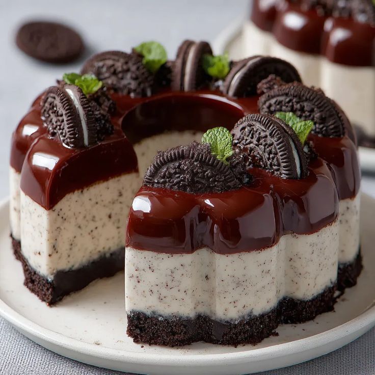 Oreo cheesecake with chocolate drip and cookie topping on white plate