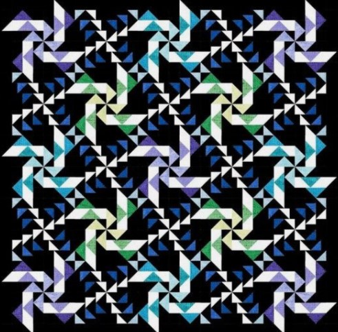 Patchwork quilt featuring a swirling wind-inspired geometric pattern in bright colors