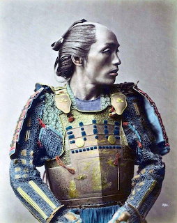 Colorized portrait of a Japanese samurai in traditional ornate armor looking to the side