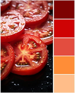 Fresh red tomato slices with water droplets next to color palette showing red and orange tones