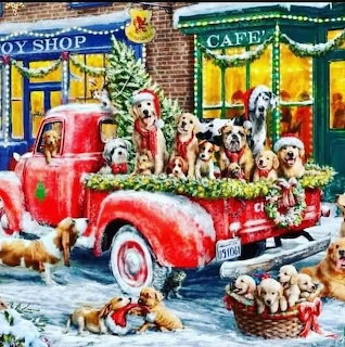 Puppies wearing Santa hats on red vintage truck in festive Christmas village scene with snow and decorated shops