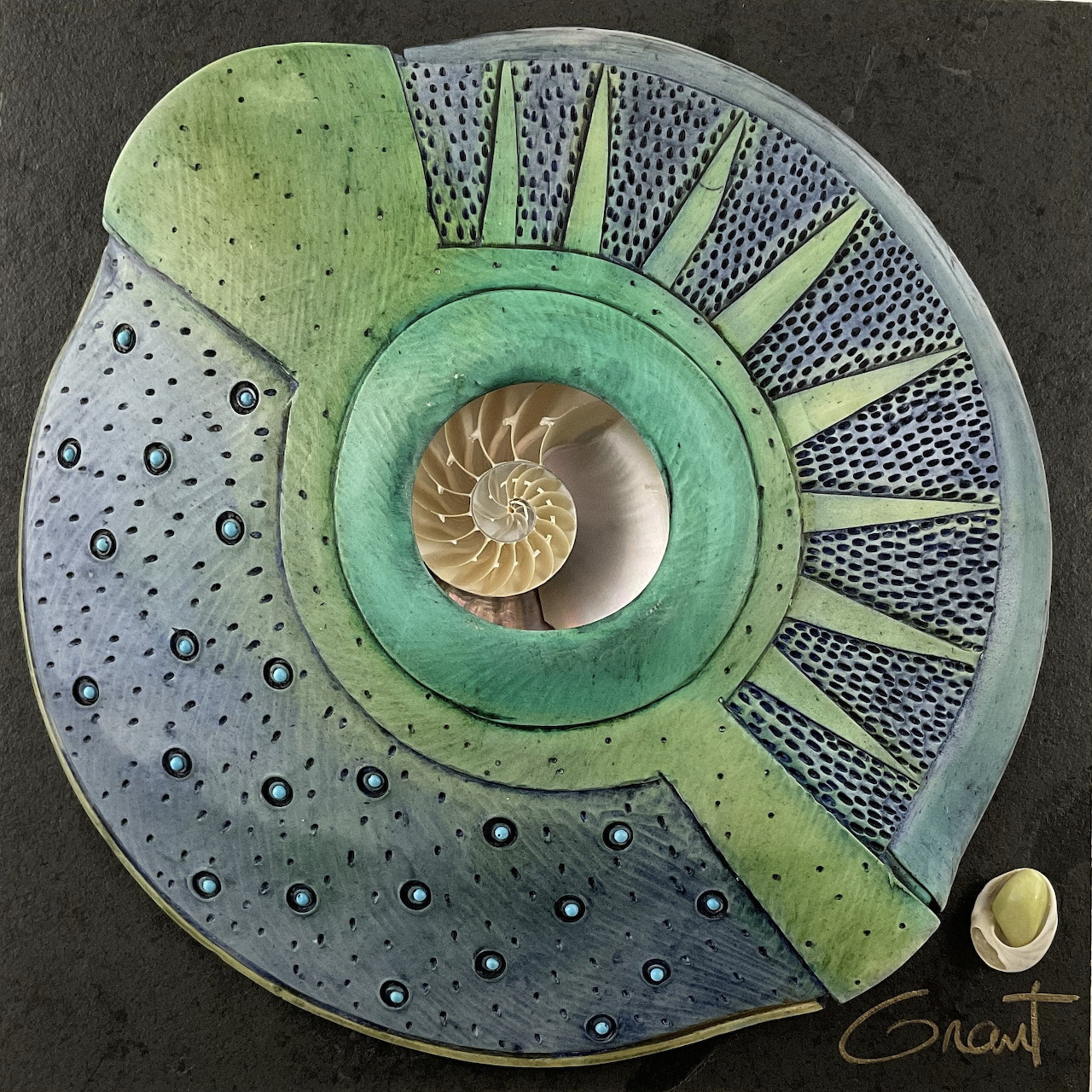 Mandala artwork with nautilus shell center and geometric patterns in earth tones