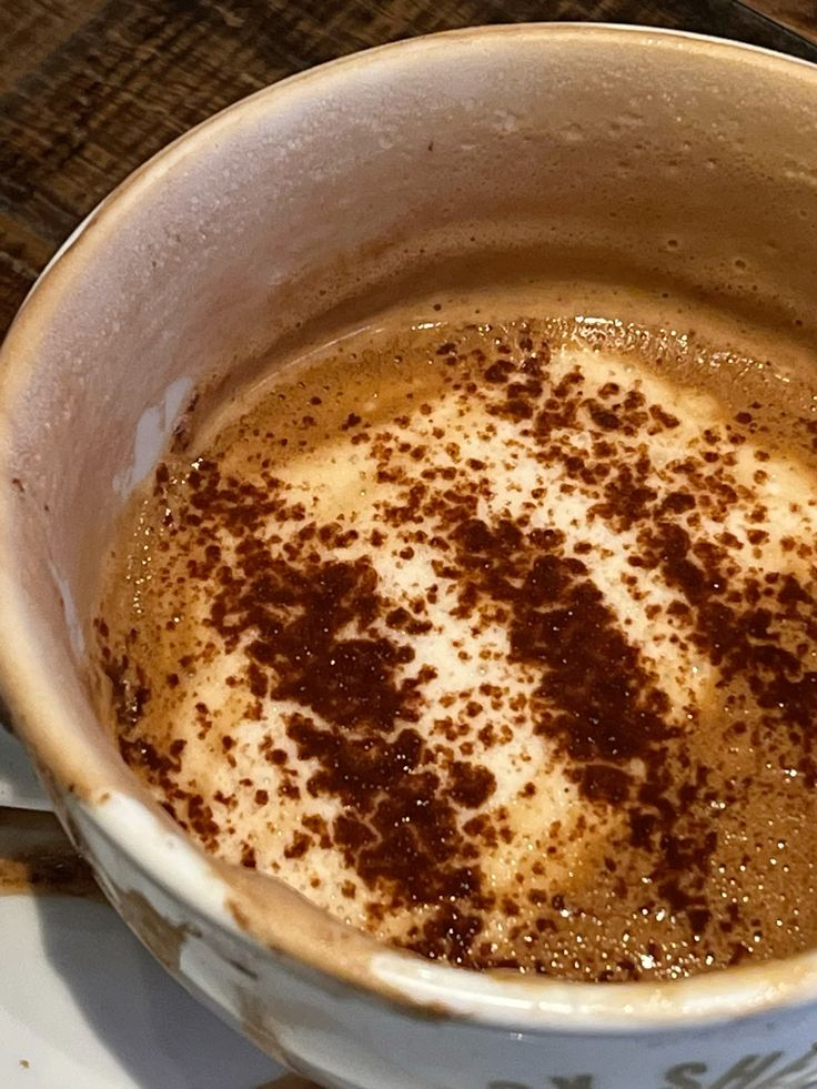 Top view of mocha coffee with chocolate powder on foam in white mug
