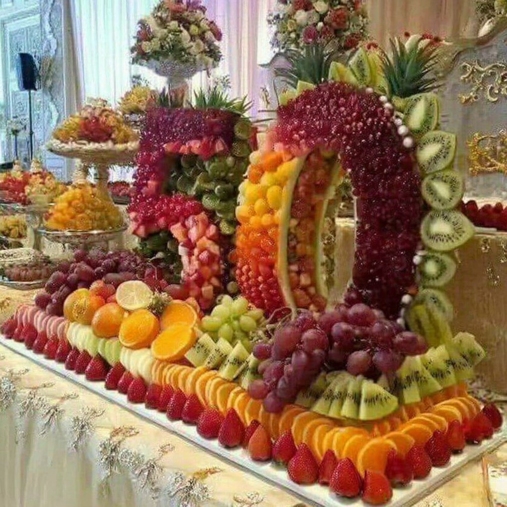 Ornate buffet table with elaborate fruit arrangements and decorative displays