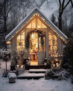 Glowing garden shed with Christmas decorations in snowy winter evening setting