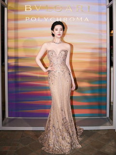 Liu Yifei in a strapless champagne beaded evening gown posing at a formal event