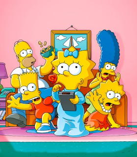 The Simpsons family sitting together on their couch in their living room