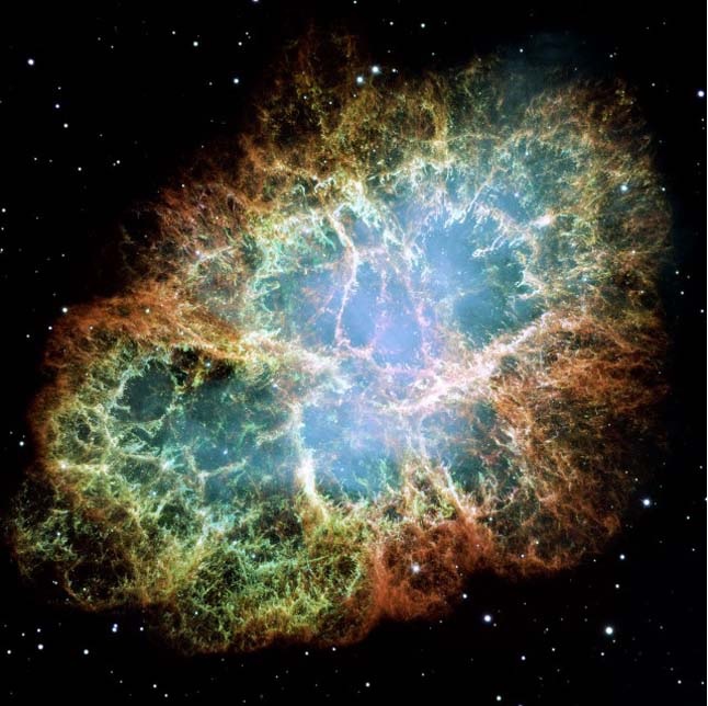 Colorful nebula with glowing filaments in deep space against a black starry background