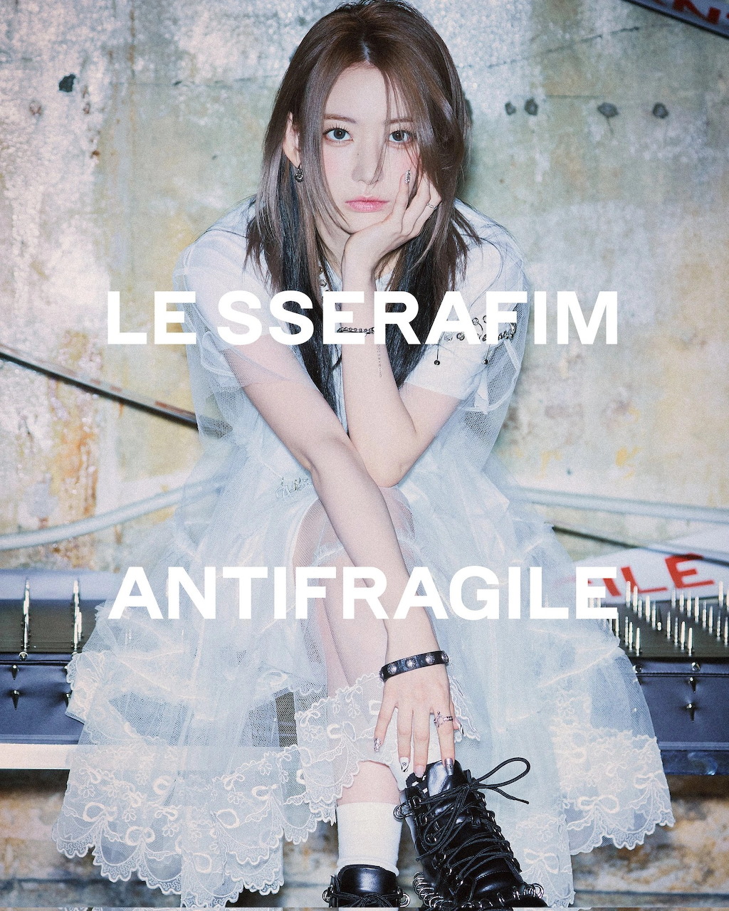 K-pop artist Sakura from LE SSERAFIM in white ruffled dress and black boots, Antifragile concept photo