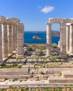 Ancient Temple of Poseidon columns overlooking the blue sea at Cape Sounion, Greece
