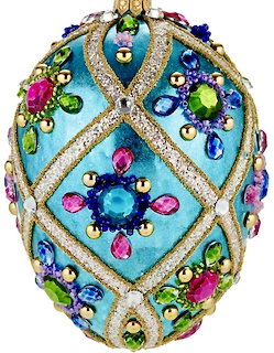 Ornate jeweled egg ornament with turquoise background, gold glitter ribbons, and colorful gemstones