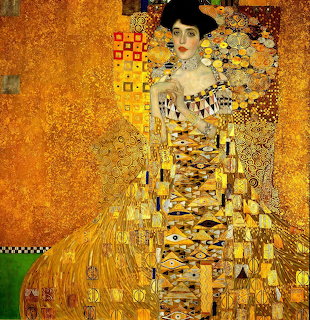 Klimt golden portrait of woman in ornate geometric patterned dress with decorative symbols and rich gold tones