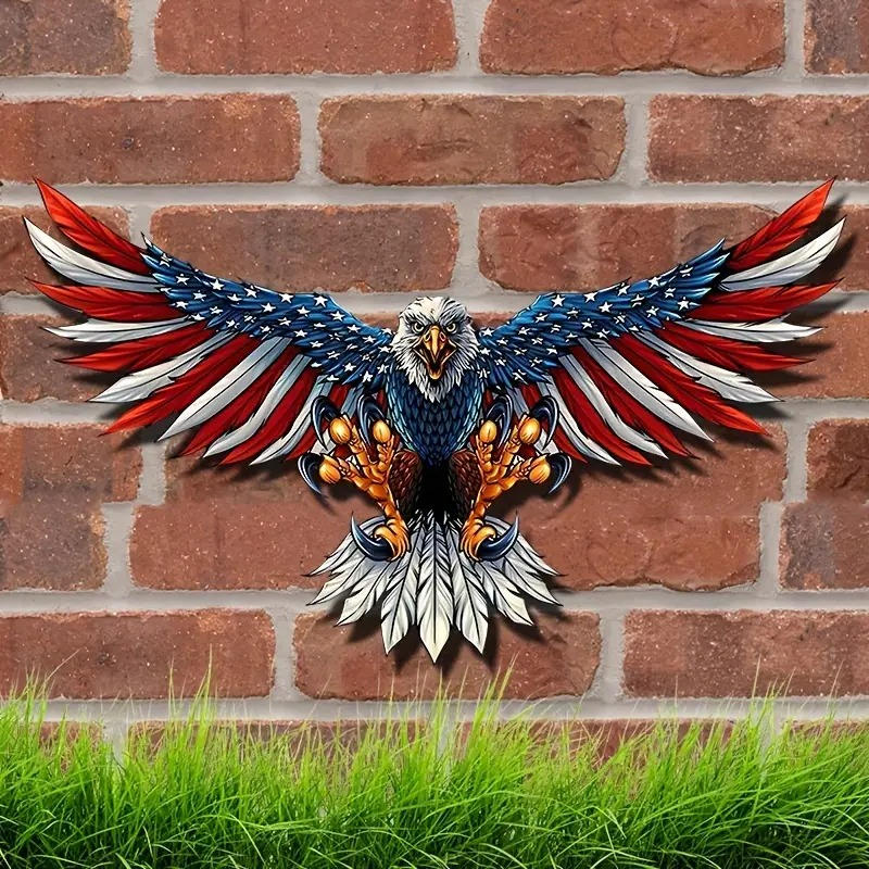 Red, white, and blue eagle wall decoration on a brick wall above green grass