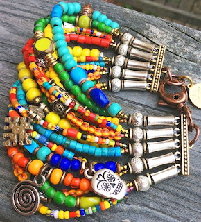 Colorful beaded bracelet with multicolored beads and silver cone charms on wood