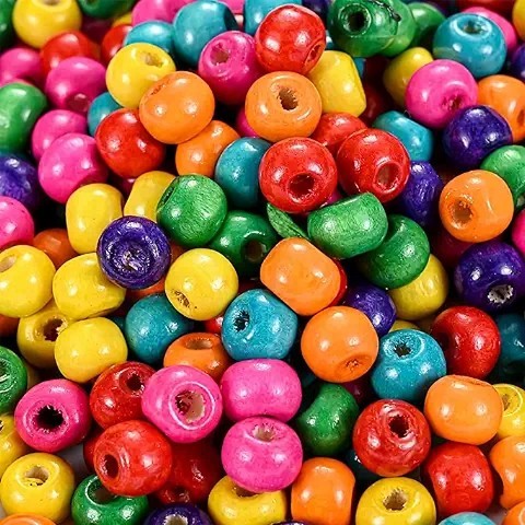 Pile of brightly colored round wooden beads in various colors including pink, yellow, green, blue, and orange