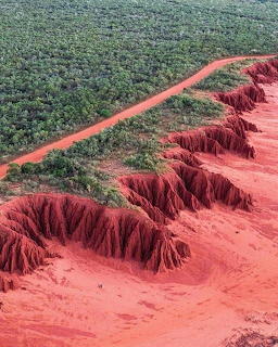 Aerial view of red rocky cliffs and outback terrain in Western Australia