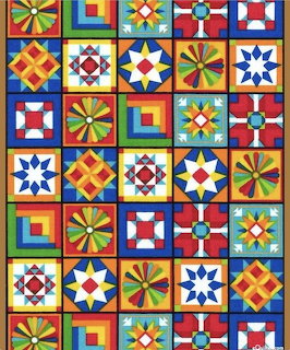 Colorful quilt pattern with geometric star and pinwheel blocks in primary colors arranged in a grid