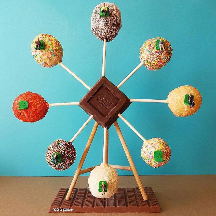 Miniature donuts arranged on sticks in ferris wheel formation around chocolate square centerpiece