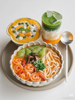 Korean meal with noodle bowl, creamy soup, and green tea layered dessert arranged on white surface