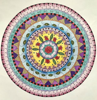 Circular mandala with layered geometric patterns in vibrant colors radiating from center