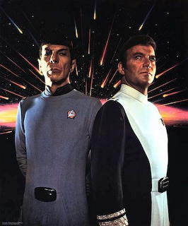 Spock in blue Starfleet uniform and Admiral Kirk in white uniform posed against a starfield backdrop