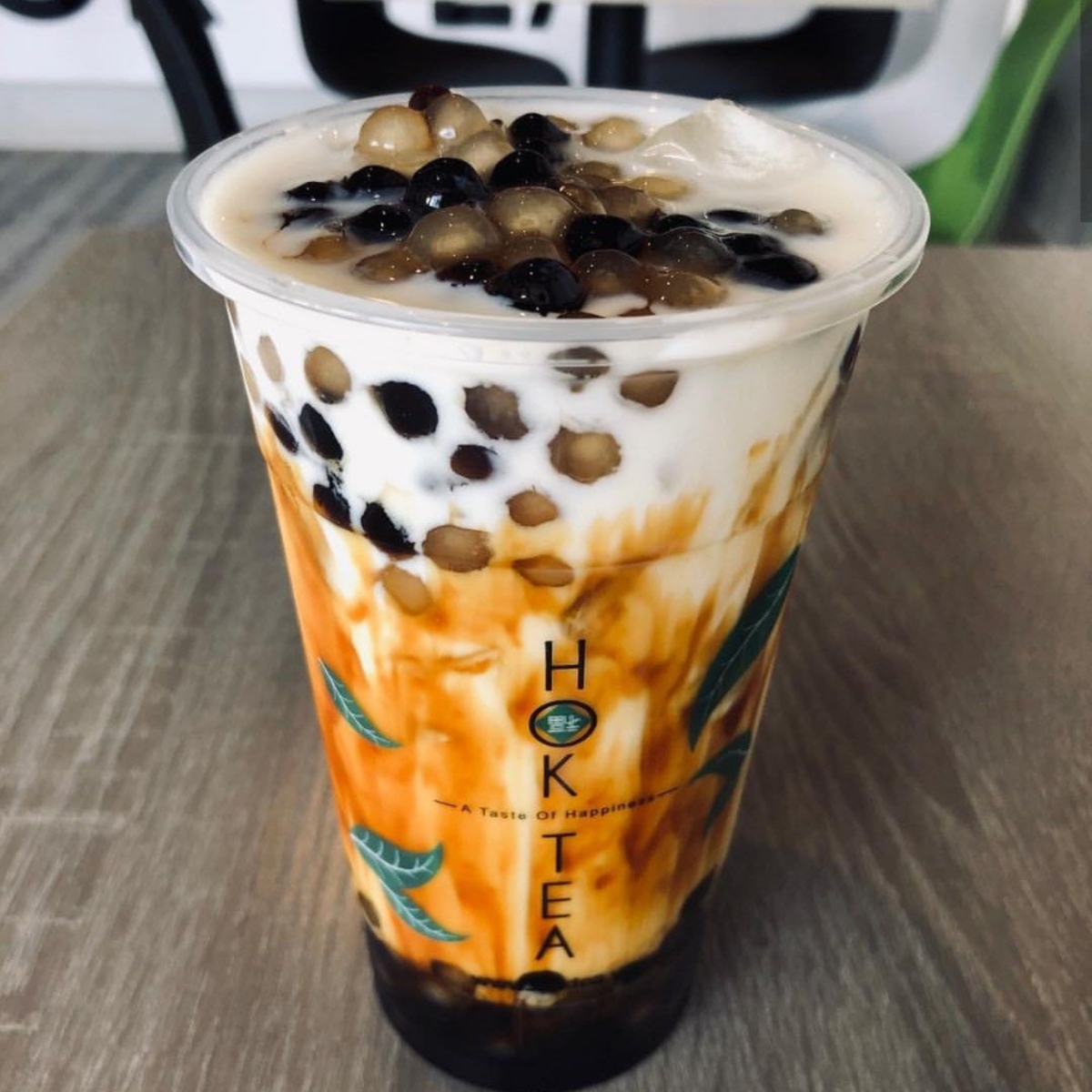 Boba milk tea with tapioca pearls and brown sugar in clear cup