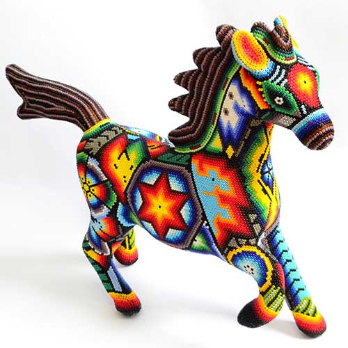Colorful Huichol-style beaded horse figurine with bright geometric patterns on a white background
