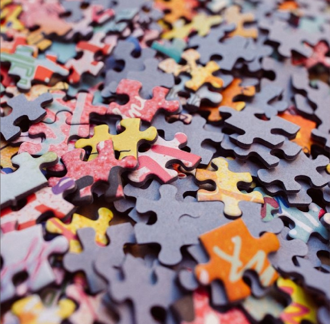Close-up of scattered colorful jigsaw puzzle pieces