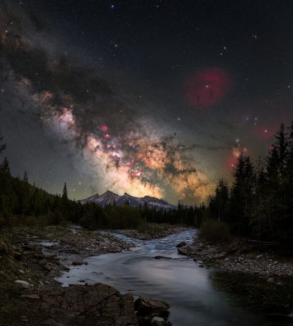 Milky Way galaxy stretching across night sky above Tatra Mountain peaks