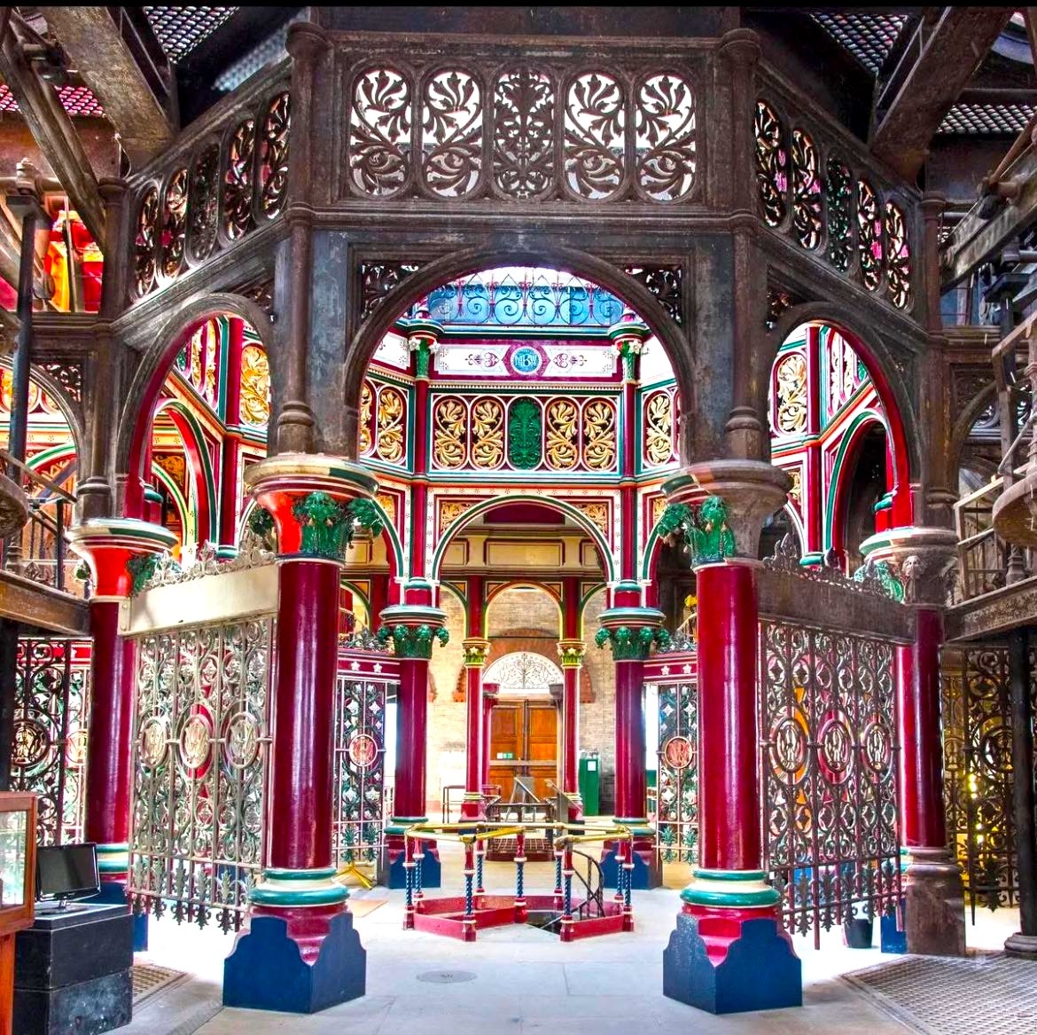 Ornate Victorian pumping station interior with colorful columns and decorative ironwork
