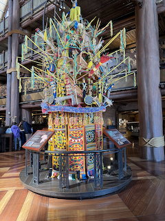 Colorful African-inspired tree sculpture in Disney Animal Kingdom Lodge lobby with decorative panels and ornaments