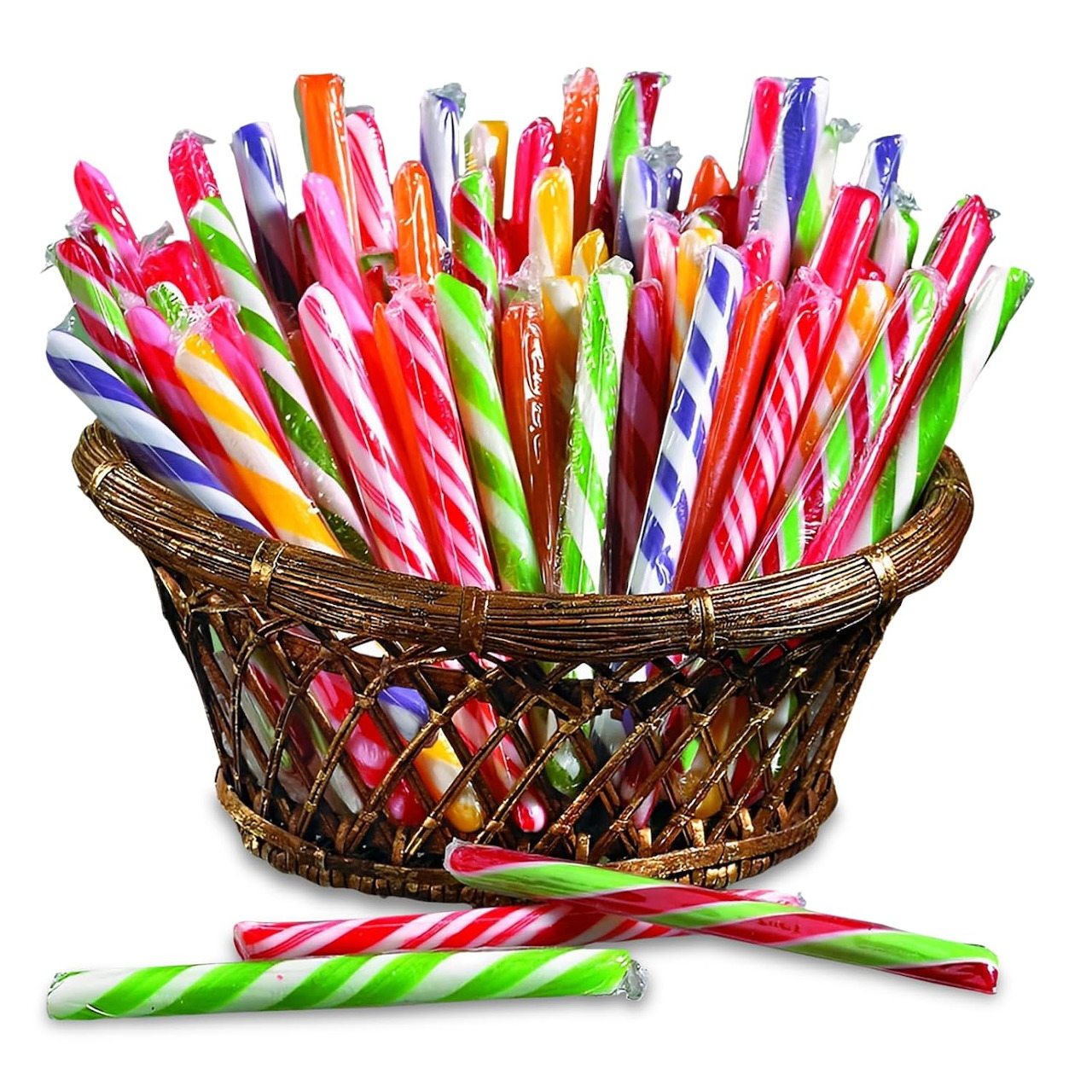Multicolored spiral-striped candy sticks in a brown woven basket with two candies lying in front