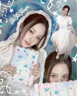 Young woman in white clothing posing with decorative card in sparkly blue collage with stars