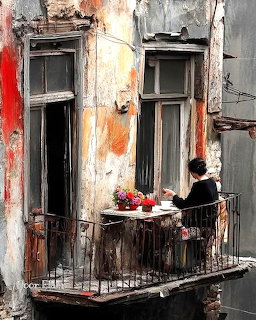 Woman on Weathered Balcony