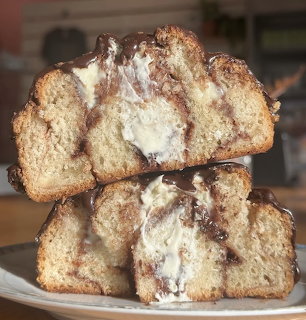 Stack of cinnamon swirl coffee cake slices on white plate