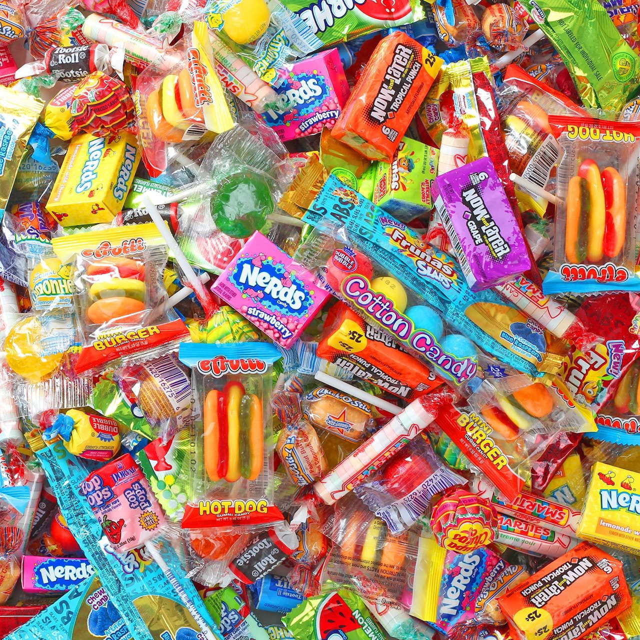 Pile of assorted colorful wrapped candies and sweets covering the entire image