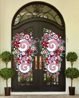 Black arched double doors decorated with red and white peppermint candy wreaths, flanked by potted topiary trees