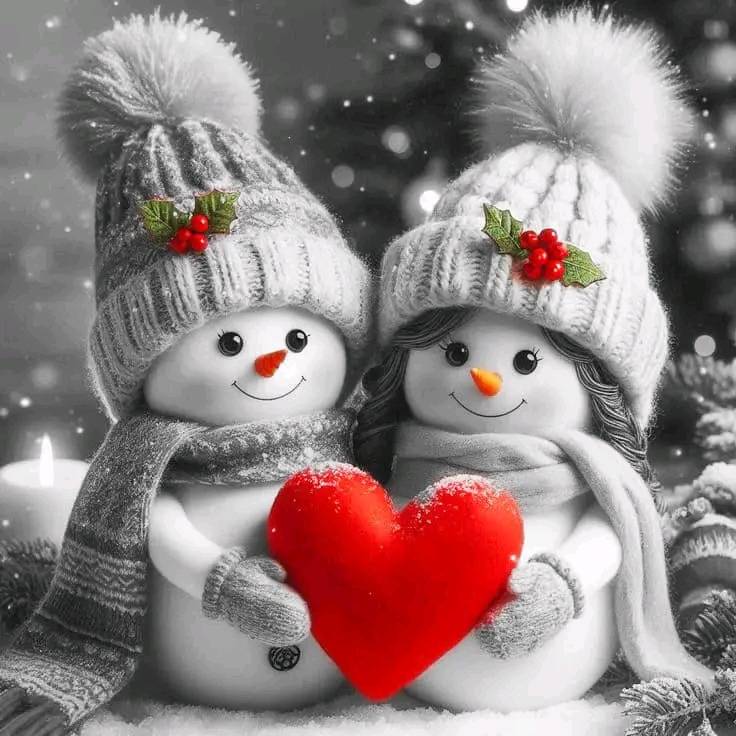 Two smiling snowmen in winter hats holding a red heart with holly berries and snow falling