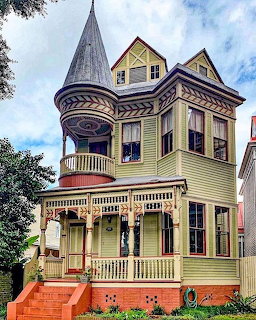 Yellow Victorian house with turret and decorative porch in Savannah