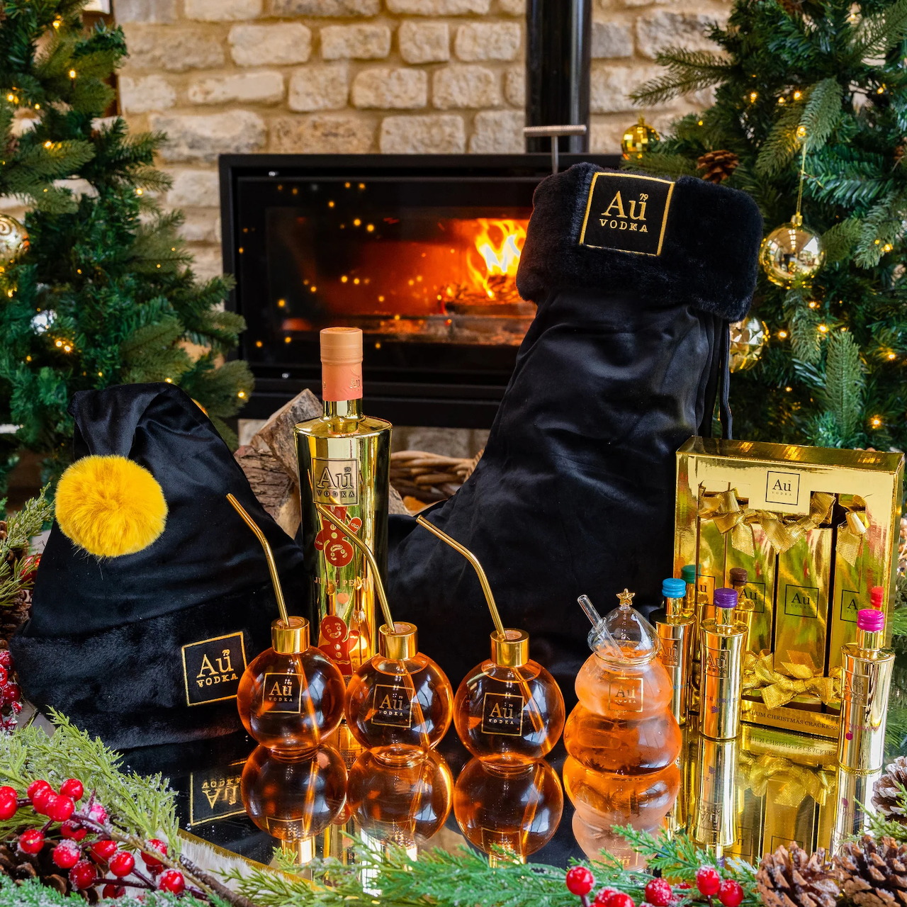 Ornate vodka bottles arranged by fireplace with Christmas trees and stocking