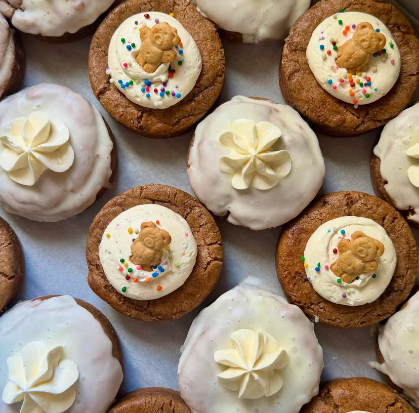 Assorted frosted cookies decorated with gingerbread men and cream swirls